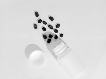 a bottle of pills sitting next to a pill holder